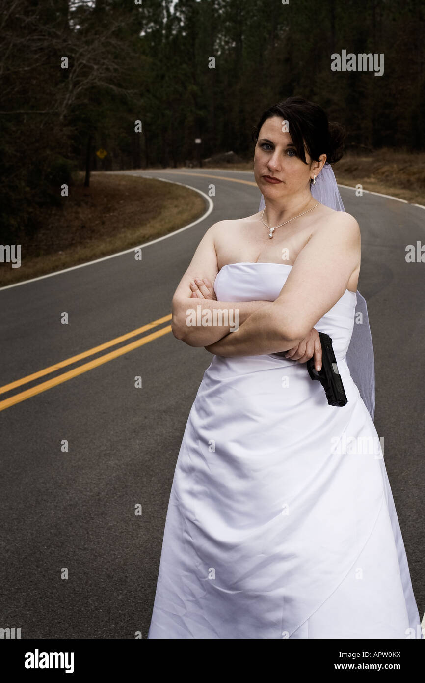 bride-in-wedding-dress-holding-a-handgun-APW0KX.jpg