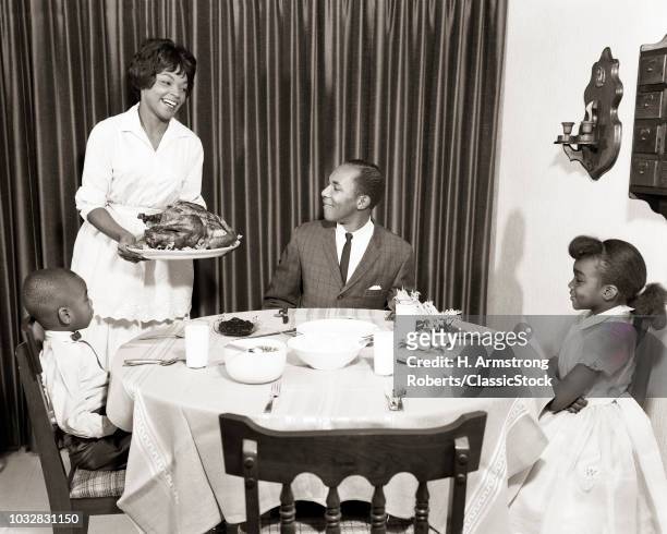 1960s-african-american-family-holiday-turkey-dinner-mother-father-2-kids.jpg