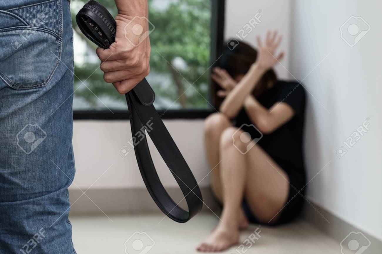 93945615-man-beat-his-fear-wife-on-the-floor-with-belt-crime-and-violence-concept- (1).jpg