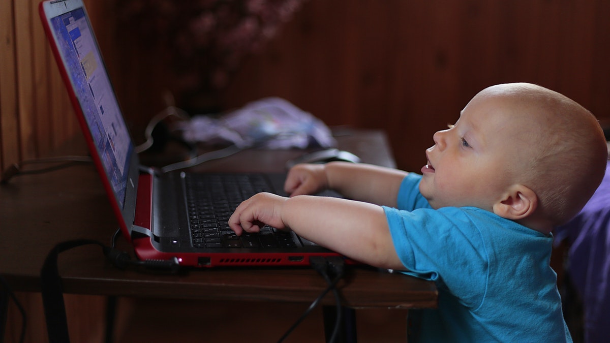 boy-wearing-blue-t-shirt-using-black-laptop-computer-in-a-159533.jpg
