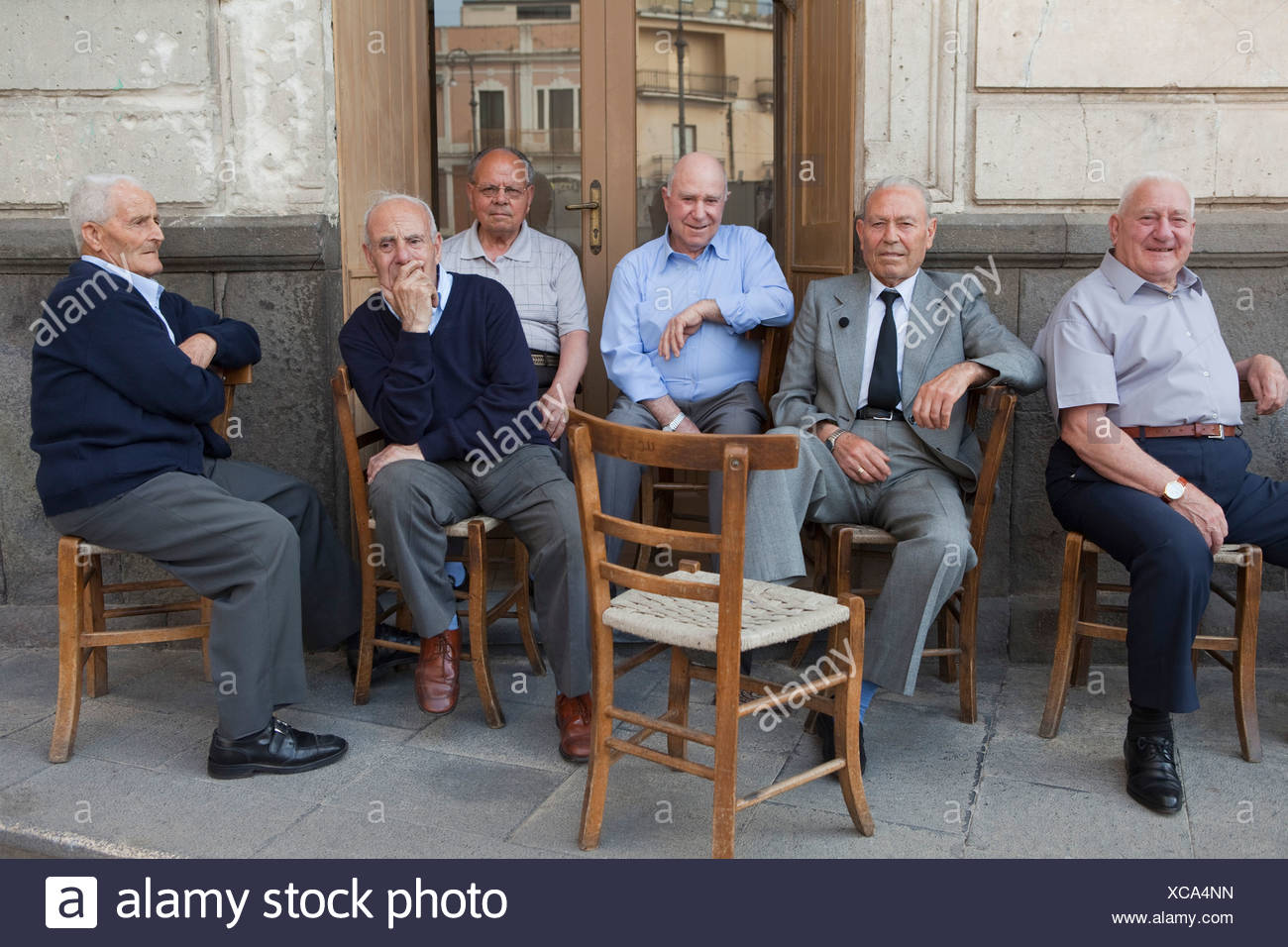 six-old-men-sitting-outside-on-chairs-XCA4NN.jpg