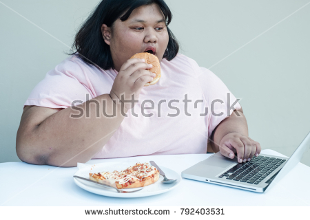 stock-photo-fat-woman-eats-a-hamburger-and-plays-computer-792403531.jpg