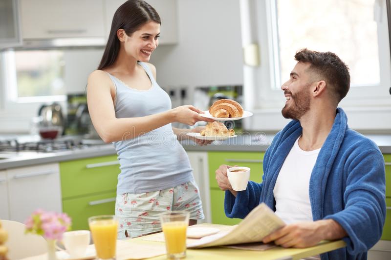 young-wife-serving-breakfast-to-husband-100047436.jpg