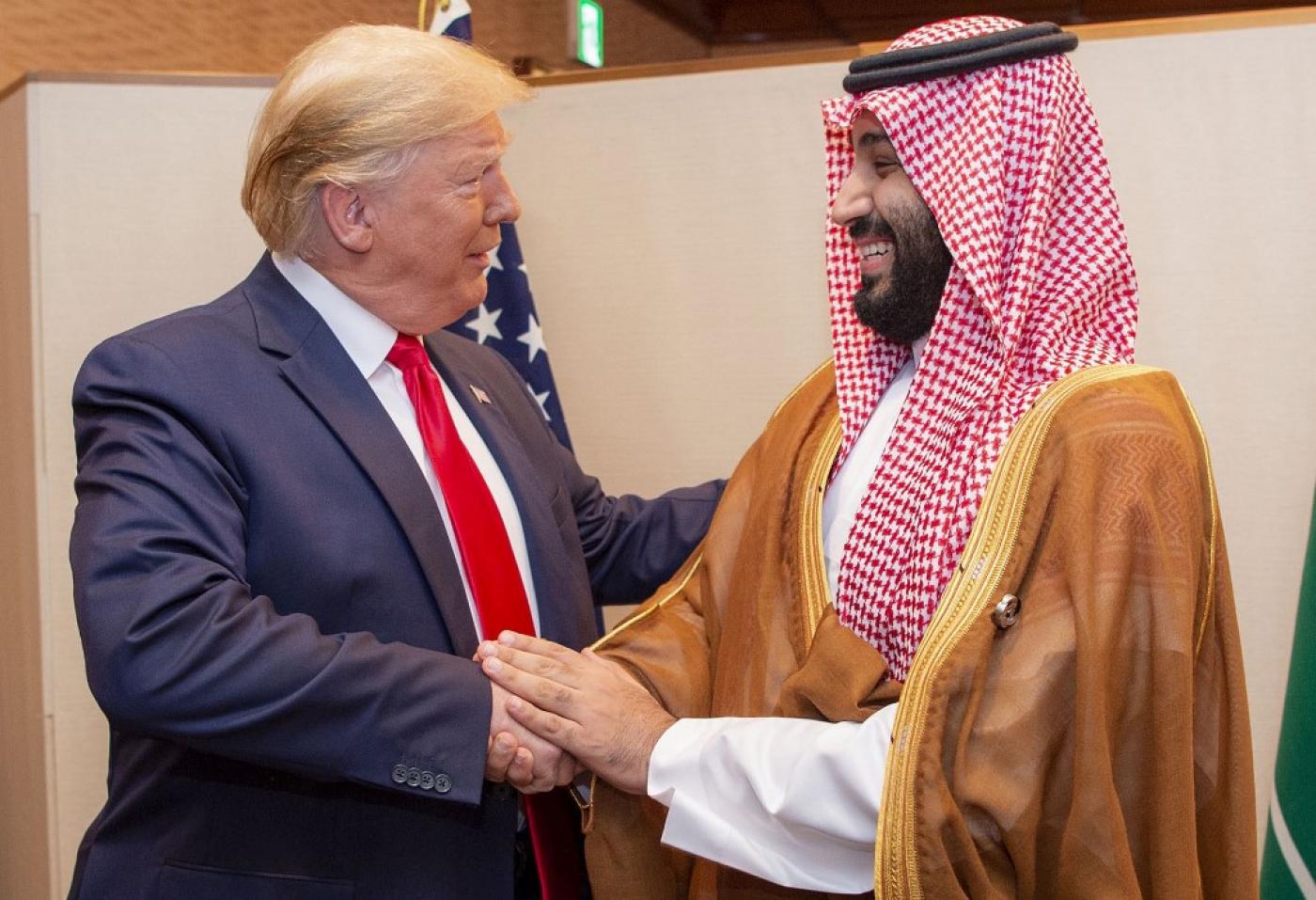 US President Donald Trump shakes hands with MBS at the 2019 G20 Summit in Osaka, Japan (Bandar al-Jaloud/Saudi Royal Palace/AFP)