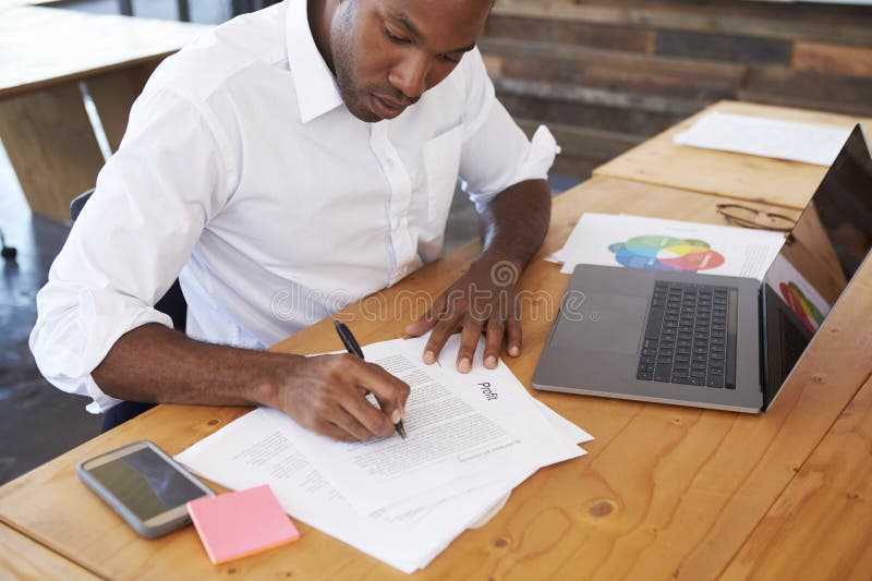 elevated-view-young-black-man-working-office-desk-93537294.jpg