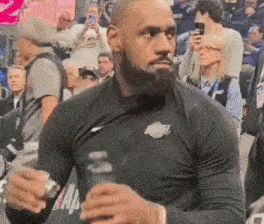 a man with a beard wearing a black nike shirt