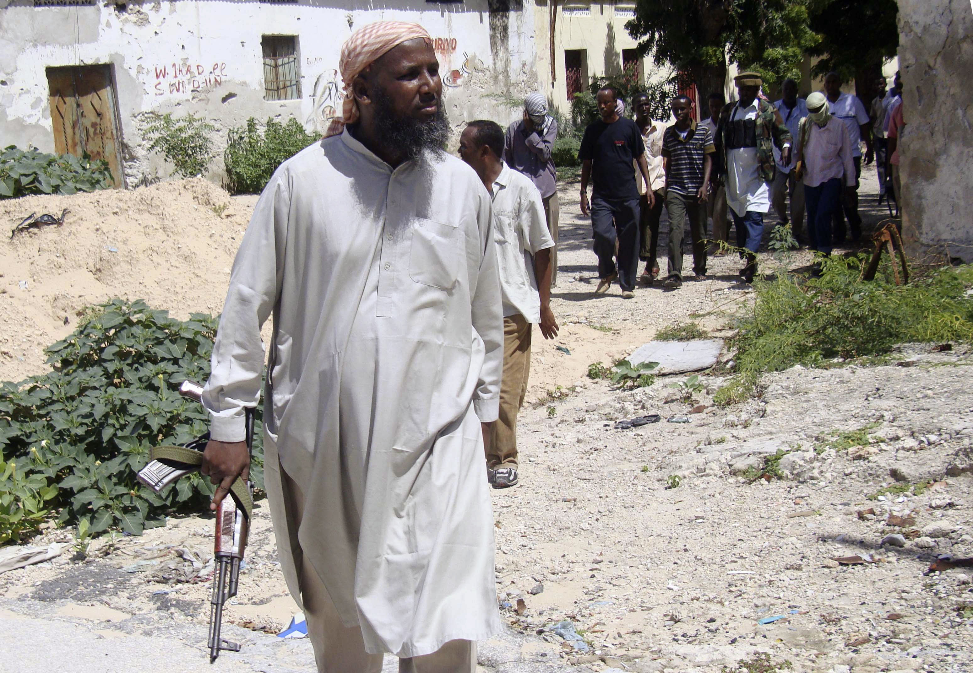 Sheikh Muktar Robow Abuu Mansuur, a senior official of the Al-Shabaab group, walks along the frontline, north of Mogadishu