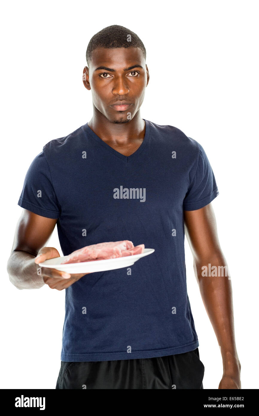 portrait-of-serious-man-holding-a-plate-of-raw-meat-E65BE2.jpg