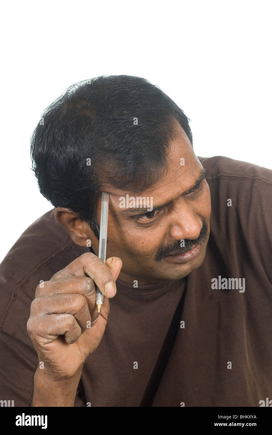 indian-man-thinking-while-holding-a-pen-against-a-white-background-BHKXYA.jpg