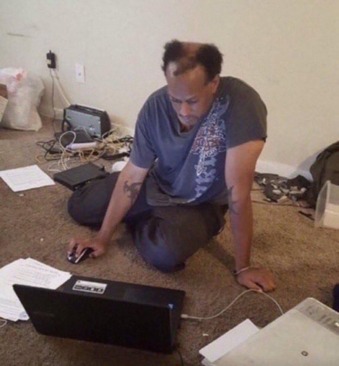 reactions on Twitter: balding man sitting on dirty carpet looking at  computer mess of cords and trash around him on the floor… 