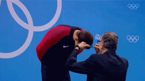 put-medal-on-neck-michael-phelps.gif