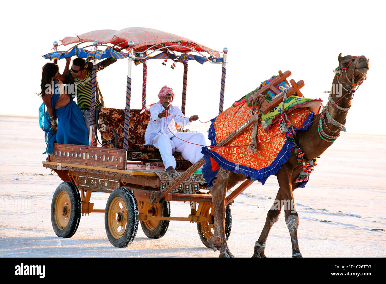 boy-and-girl-in-romantic-pose-at-camel-cart-in-rann-of-kutch-india-C26TTG.jpg