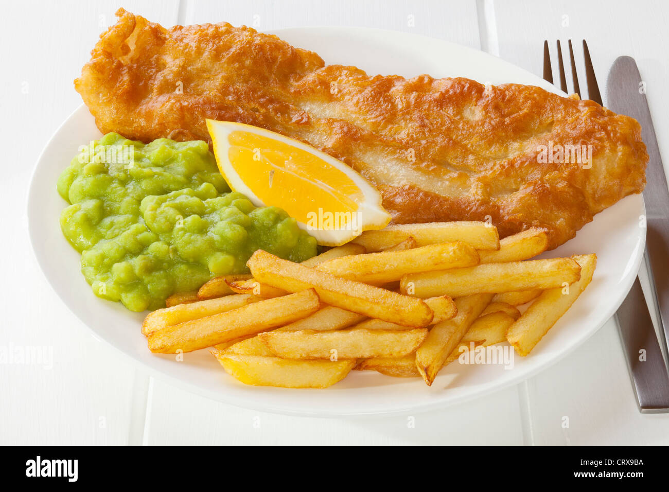 battered-fish-served-with-chips-and-mushy-peas-CRX9BA.jpg