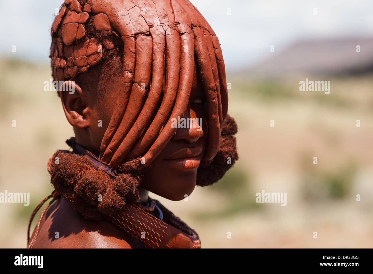 portrait-of-himba-woman-with-traditional-mud-caked-hairstyle-covering-DR23GG.jpg