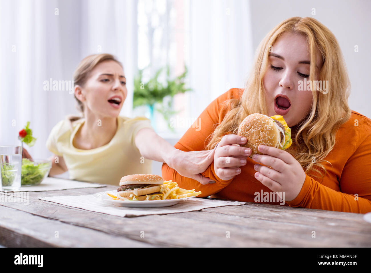 satisfied-fat-woman-eating-a-sandwich-MMAN5F.jpg