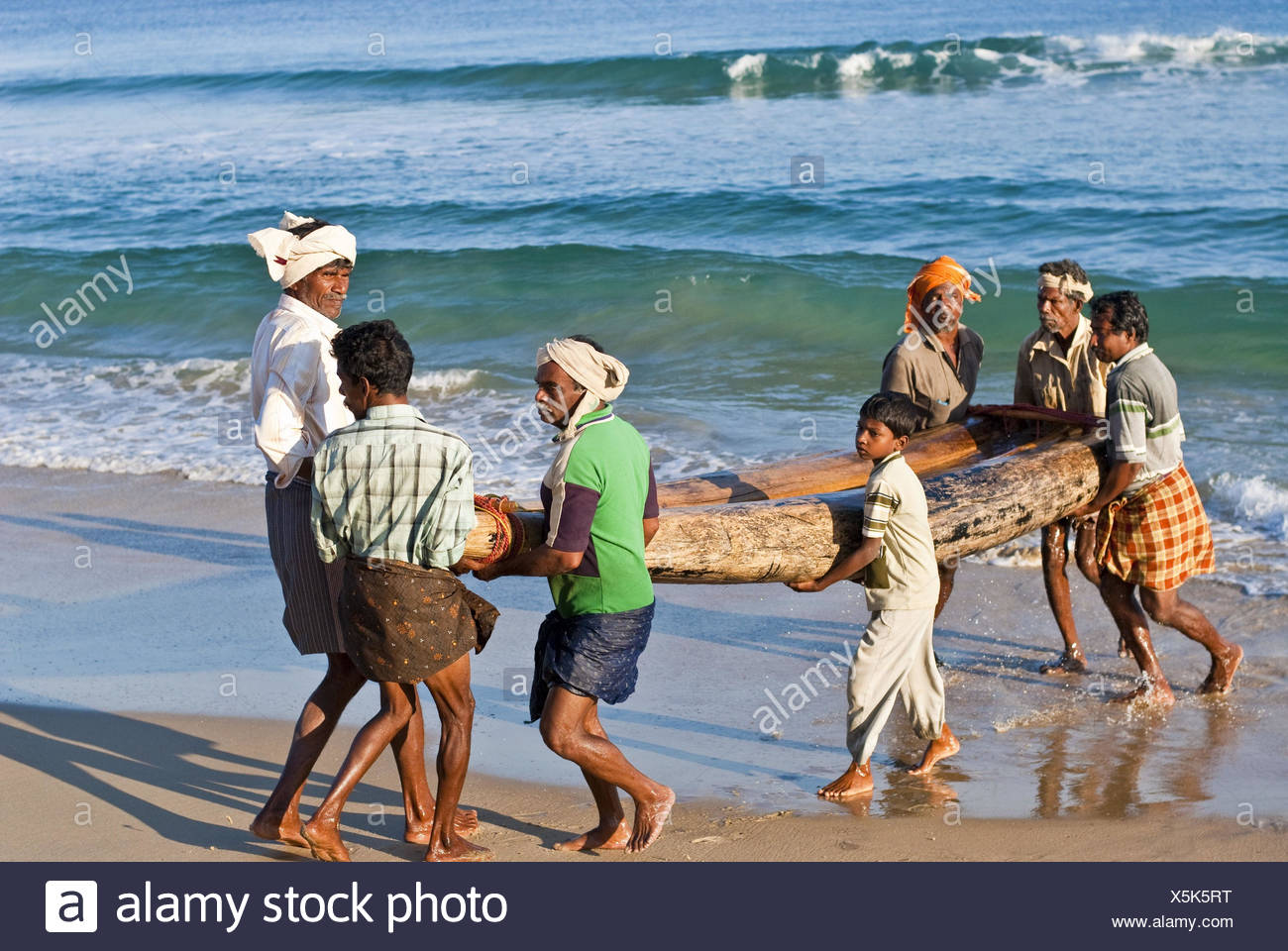 fishermen-carry-boat-from-the-water-X5K5RT.jpg