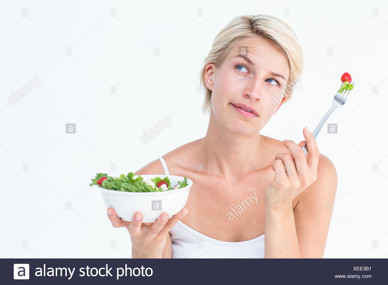 thoughtful-blonde-eating-salad-XEE3B1.jpg