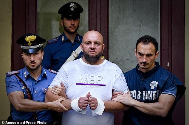 whzcXTPvff83d6b65f01d94c8de-3662292-Francesco_Danese_is_escorted_out_the_police_station_after_a_poli-a-99_1467115473703.jpg