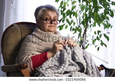 closeup-portrait-senior-woman-knitting-450w-1021406086.jpg
