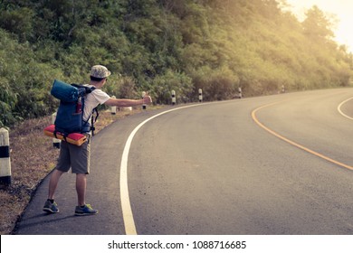 travel-man-hitchhiking-hitchhiker-by-260nw-1088716685.jpg