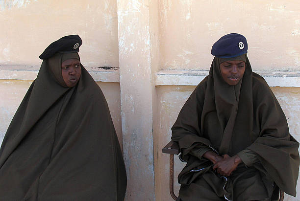 mogadishu-somalia-hijab-clad-somali-policewomen-guard-inside-the-of-picture-id71707999