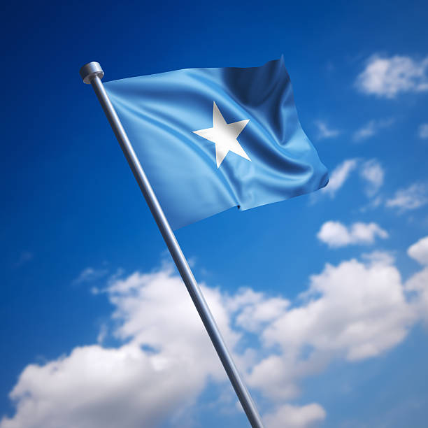 flag-of-somalia-against-blue-sky-picture-id465632763