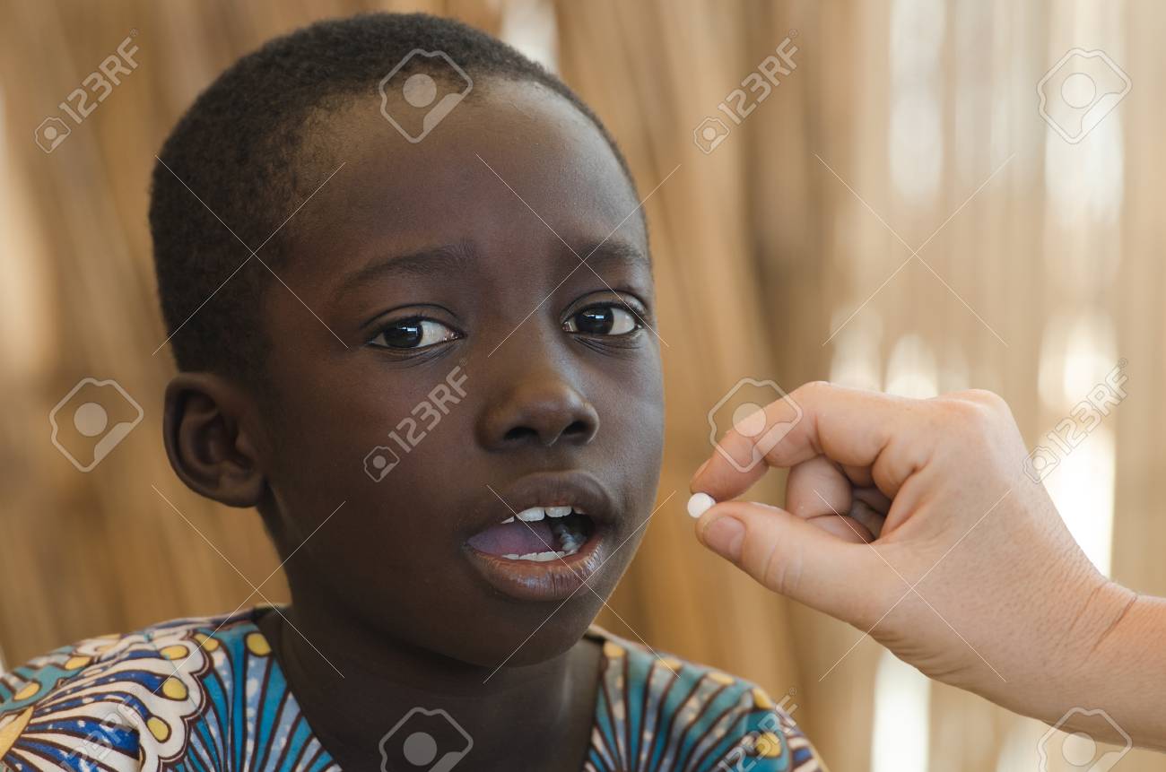 85888995-white-doctor-giving-a-pill-to-a-little-black-african-boy.jpg