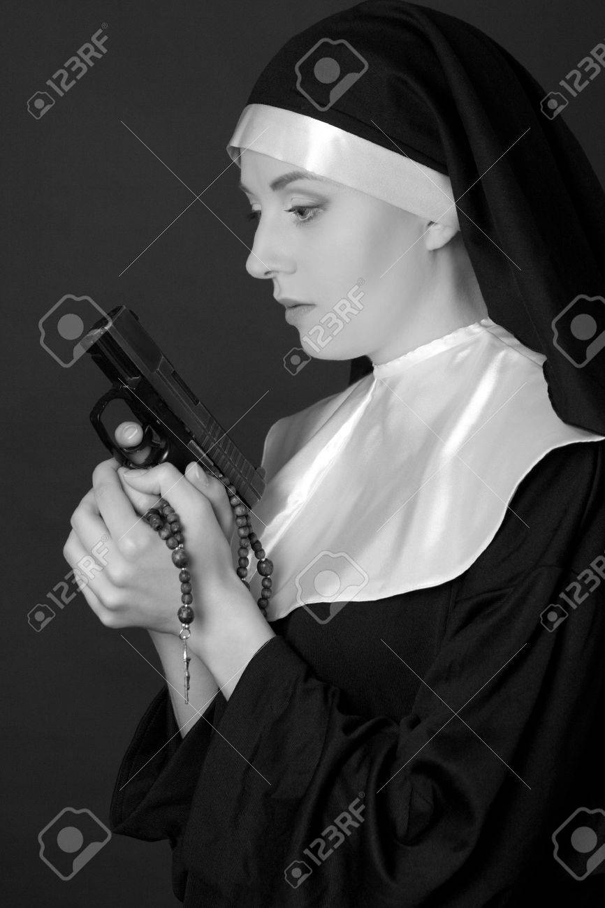 38820893-black-and-white-portrait-of-young-woman-nun-holding-gun.jpg