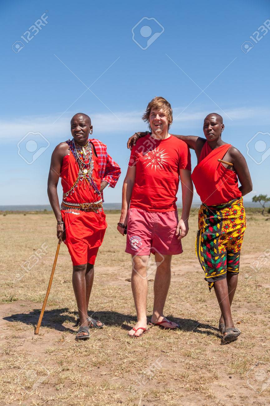 37797046-masai-mara-kenya-africa-feb-12-masai-men-in-traditional-clothes-and-european-tourists-review-of-dail.jpg