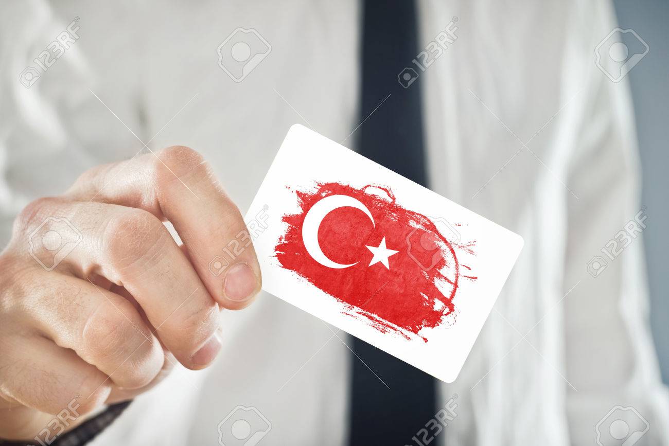 27432545-turkish-businessman-holding-business-card-with-turkey-flag-international-cooperation-investments-bus.jpg