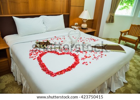 stock-photo-beautiful-wedding-bed-decorated-423750415.jpg
