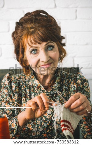 stock-photo-granny-character-at-christmas-eve-old-woman-knitting-socks-from-colorful-thread-needlework-and-750583312.jpg