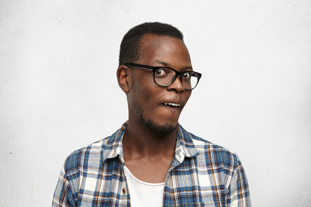 74225810-studio-shot-of-stylish-african-male-in-glasses-staring-at-camera-having-crazy-look-funny-young-dark-.jpg